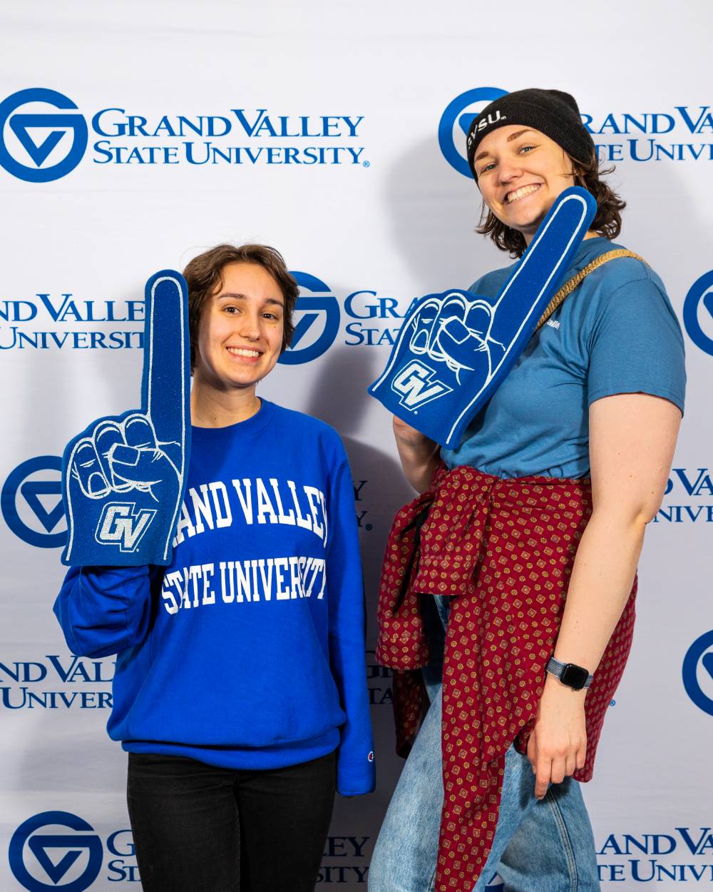 individuals smiling with blue grand valley shirt